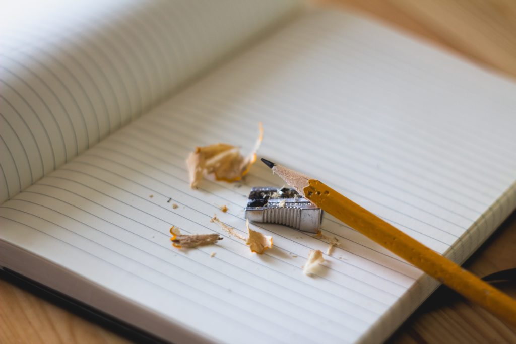 notebook and pencil with pencil sharpener and shavings for writing resolutions for 2020