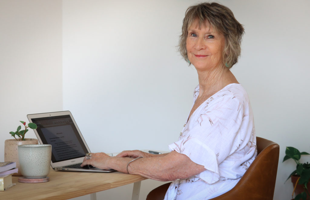 gail sitting at laptop for post trends in writing for 2021