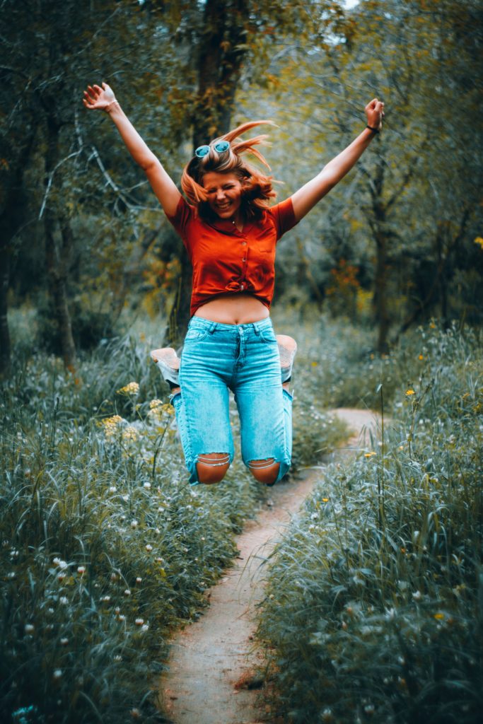 Pic of woman jumping for joy for post How a book coach can help organise your writing