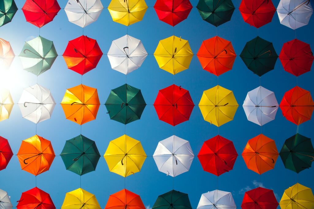 Colourful umbrellas on a wire - Use These Three Simple Steps to Master Repetition as a Device in Writing