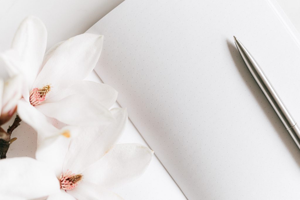 page pen and white orchid for post planning your writing